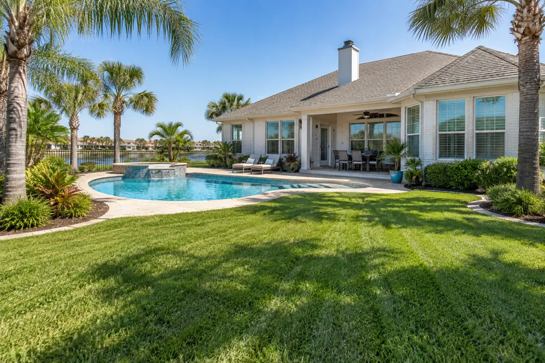 Residential home with maintained lawn and pool in Corpus Christi